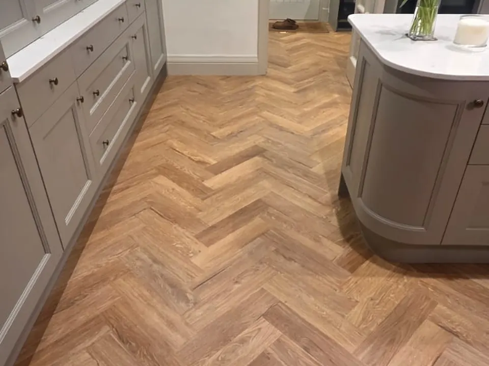 Oak-effect herringbone running the length of a galley kitchen