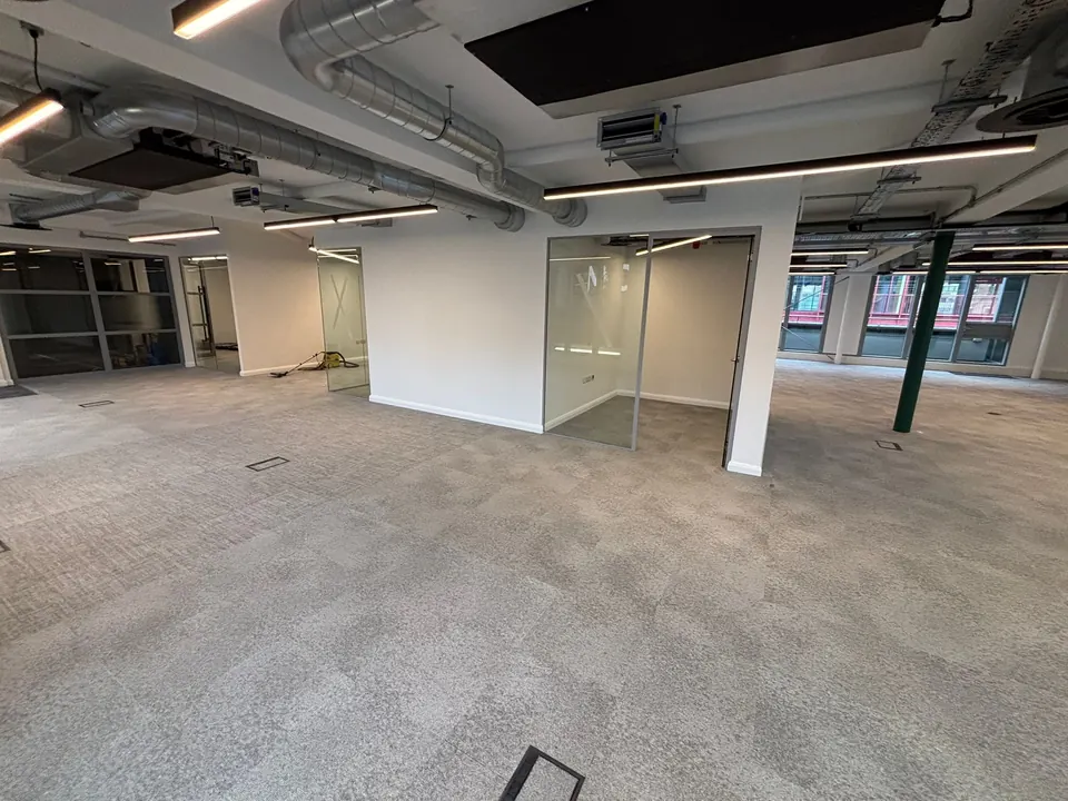 Carpet tiles fitted around glass meeting rooms in an office