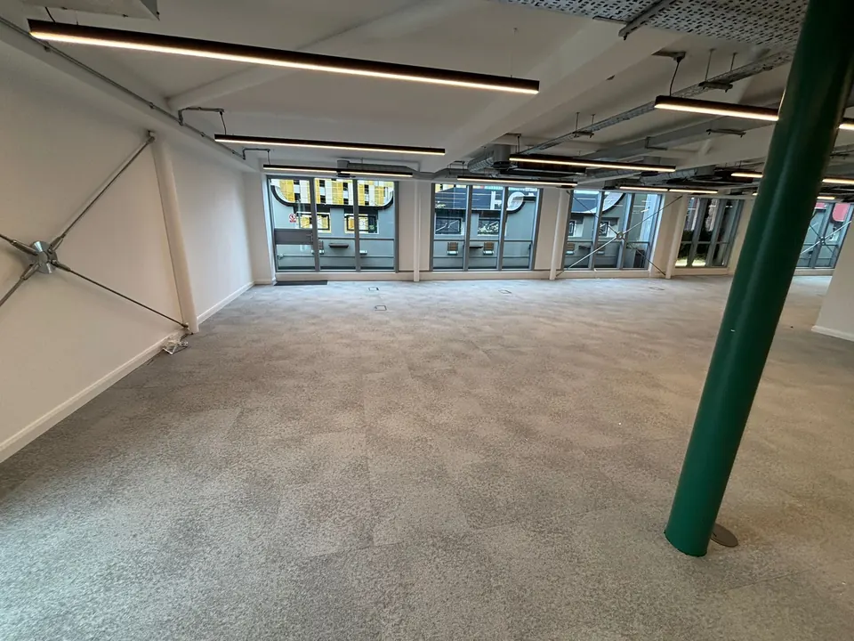 Grey carpet tiles fitted across an open-plan office floor