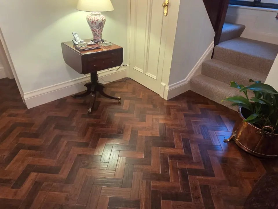 Dark wood-effect block herringbone flooring in a traditional hallway
